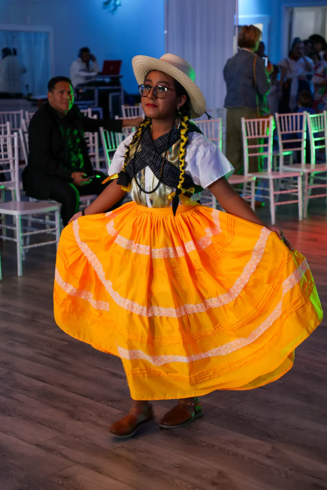 Yellow tiered skirt with white lace, blouse, scarf, and palm hat at Oaxaca en Utah’s Fashion Show 2025