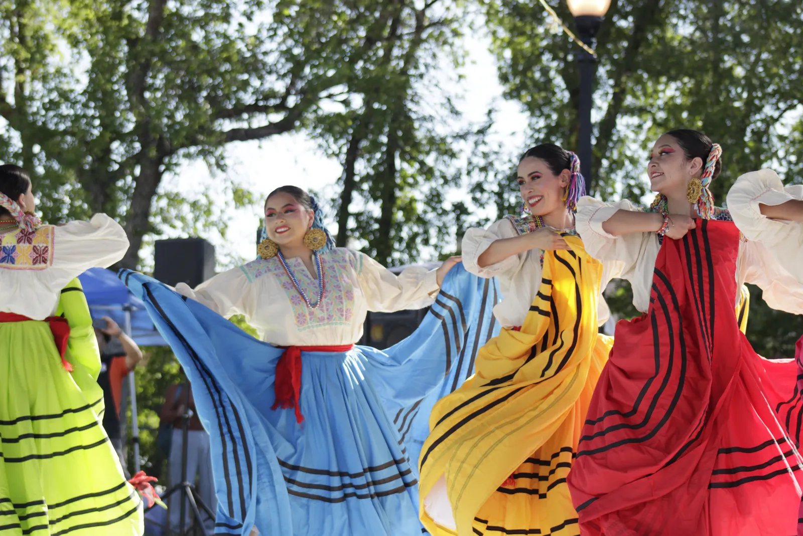 Dancers display colorful skirts with black ribbon bands at La Guelaguetza 2026