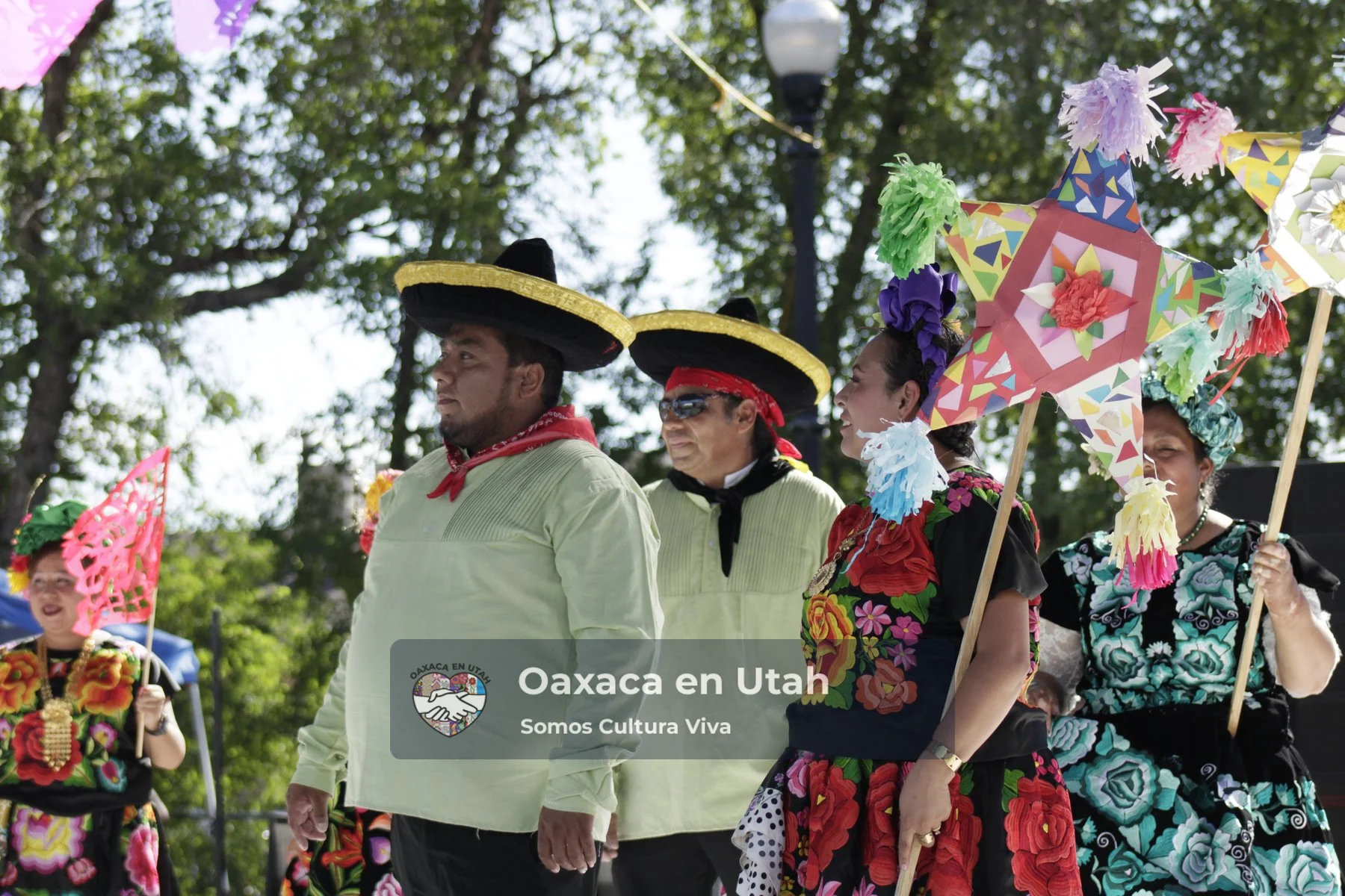 Oaxaca en Utah dancers together at an outdoor celebration