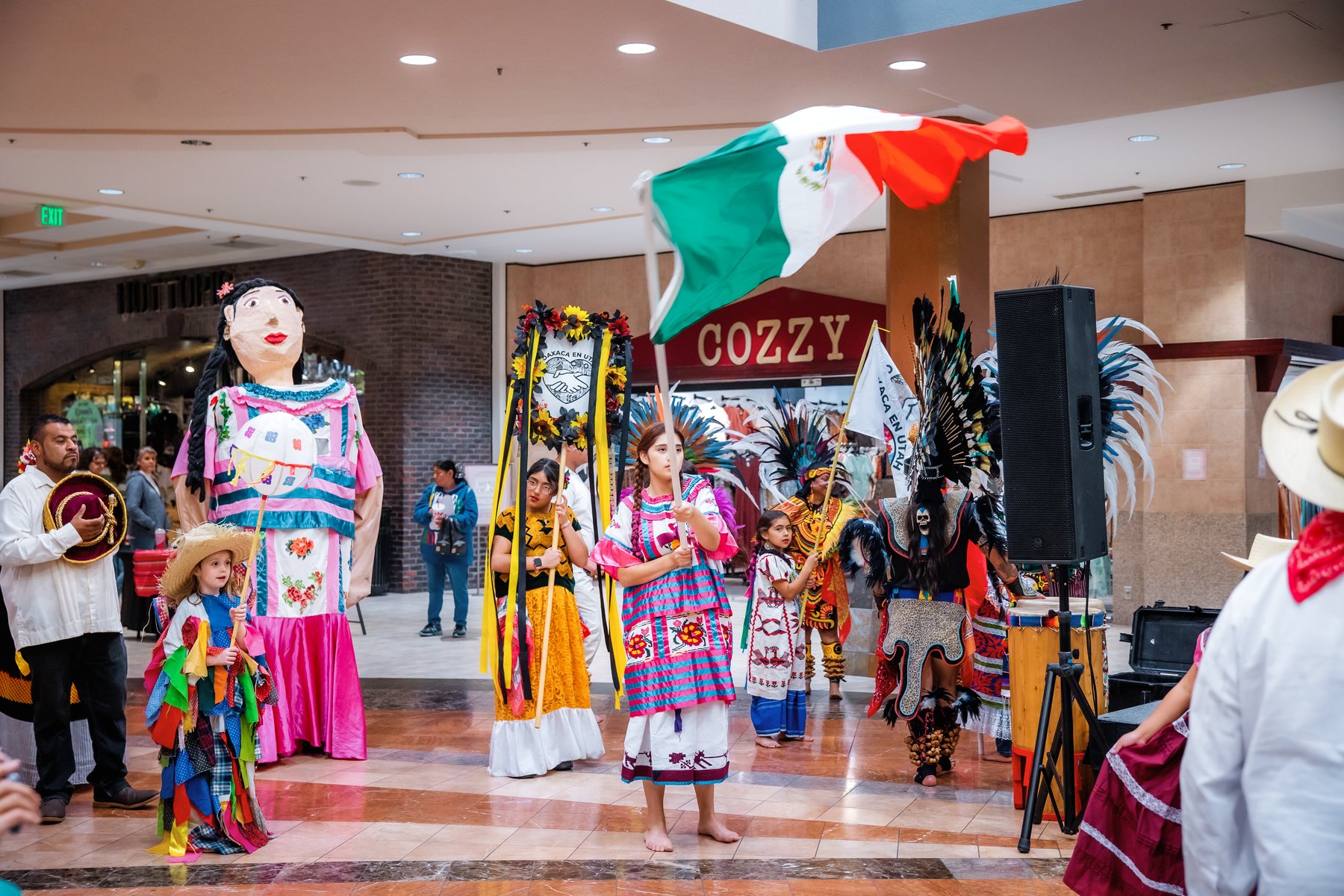 Oaxaca en Utah participants carry flags and community symbols during the Utah Cultural Heritage Celebration