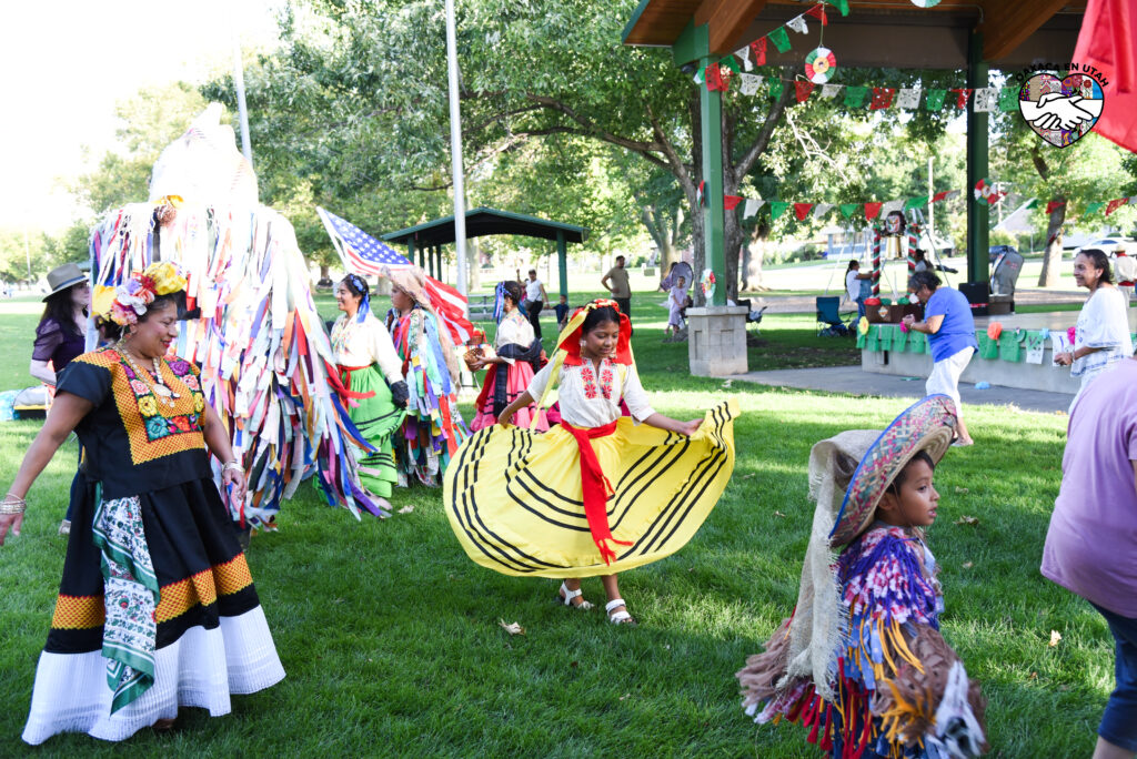 Oaxaca en Utah community members dancing together at Heritage Park