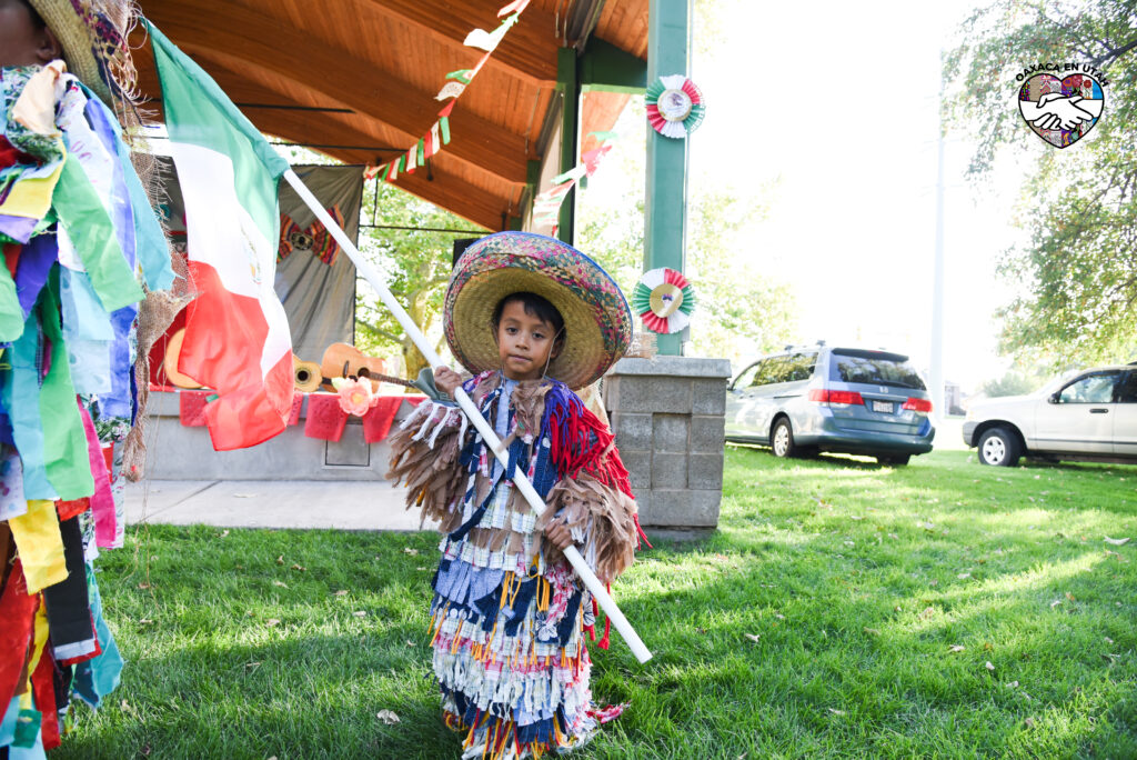Young participant in traditional clothing at an Oaxaca en Utah community event
