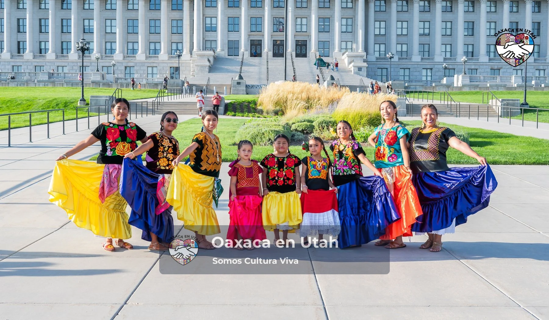 A group displays colorful skirts in a line outside the Utah State Capitol
