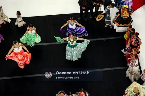 Four participants display red, green, purple, and blue skirts in formation